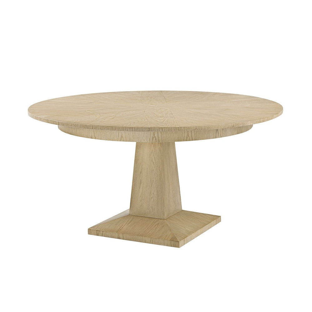 Round oak dining table, angled side view.