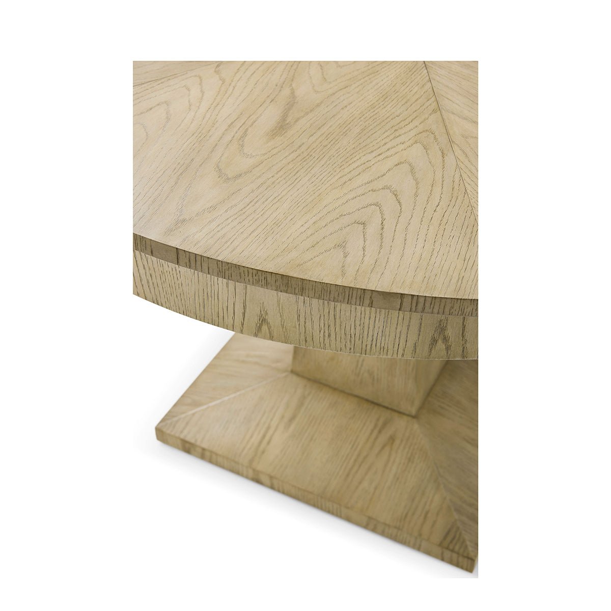 Close-up of oak dining table edge and base.