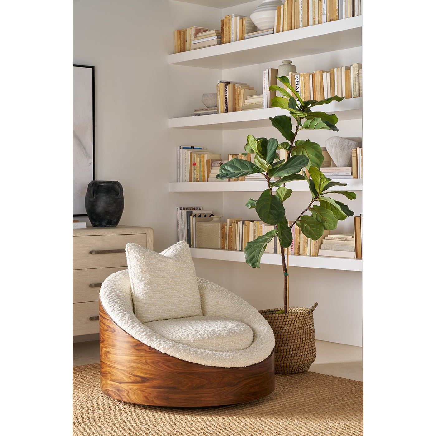 Lounge chair in cozy living room with bookshelf.