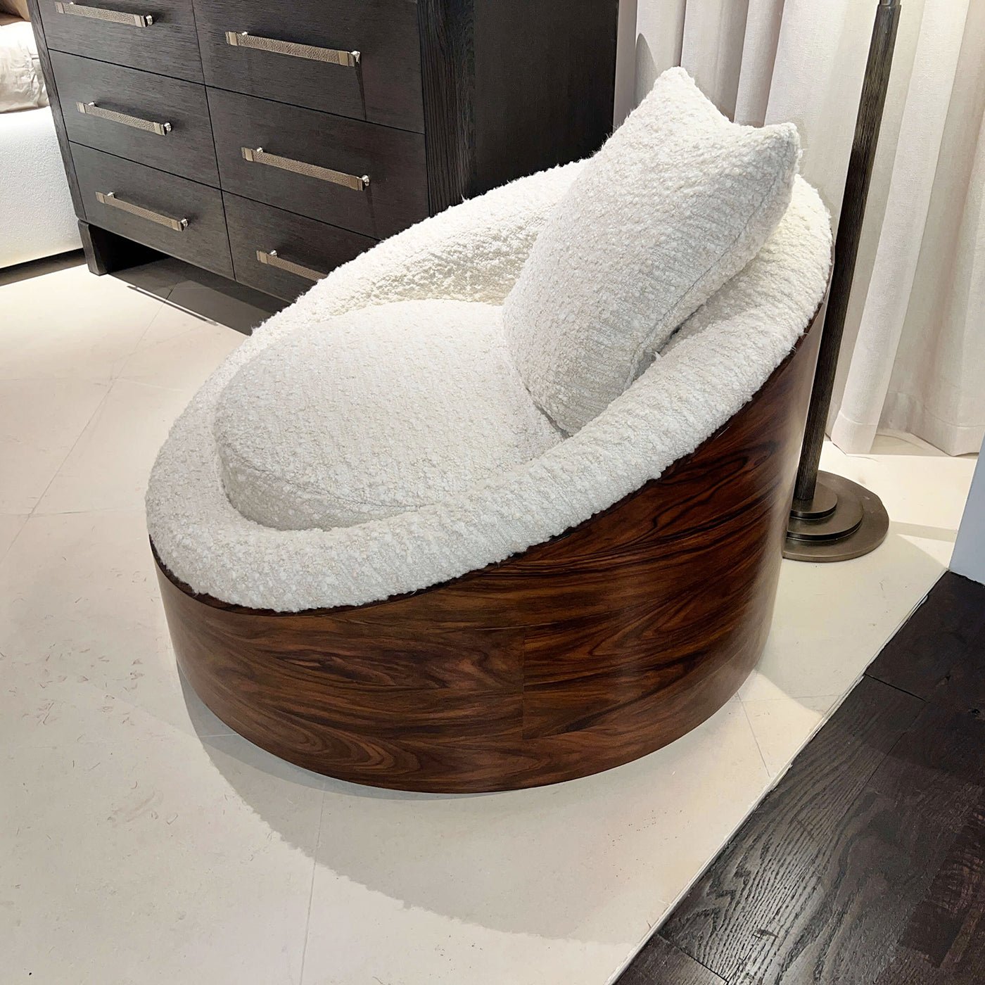 Top angle of lounge chair, rich wood, cushion.