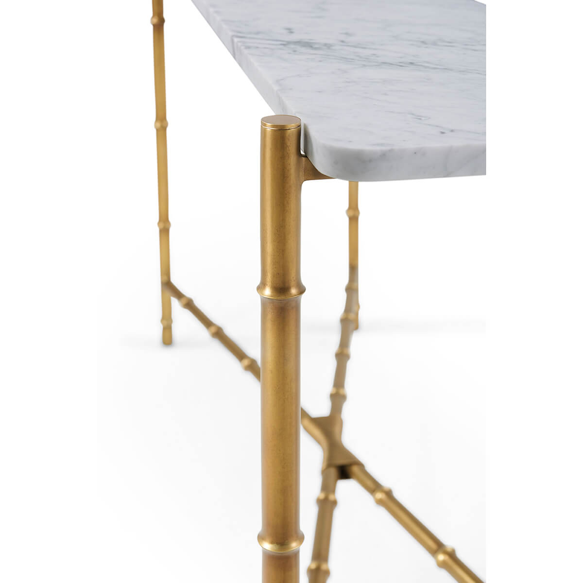 Close-up of marble top and gold legs on console table.