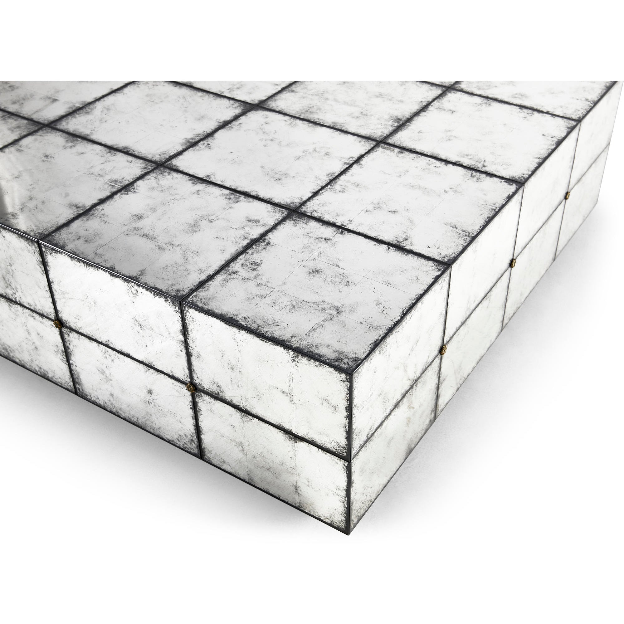Close-up, mirrored tile surface, cocktail table edge.