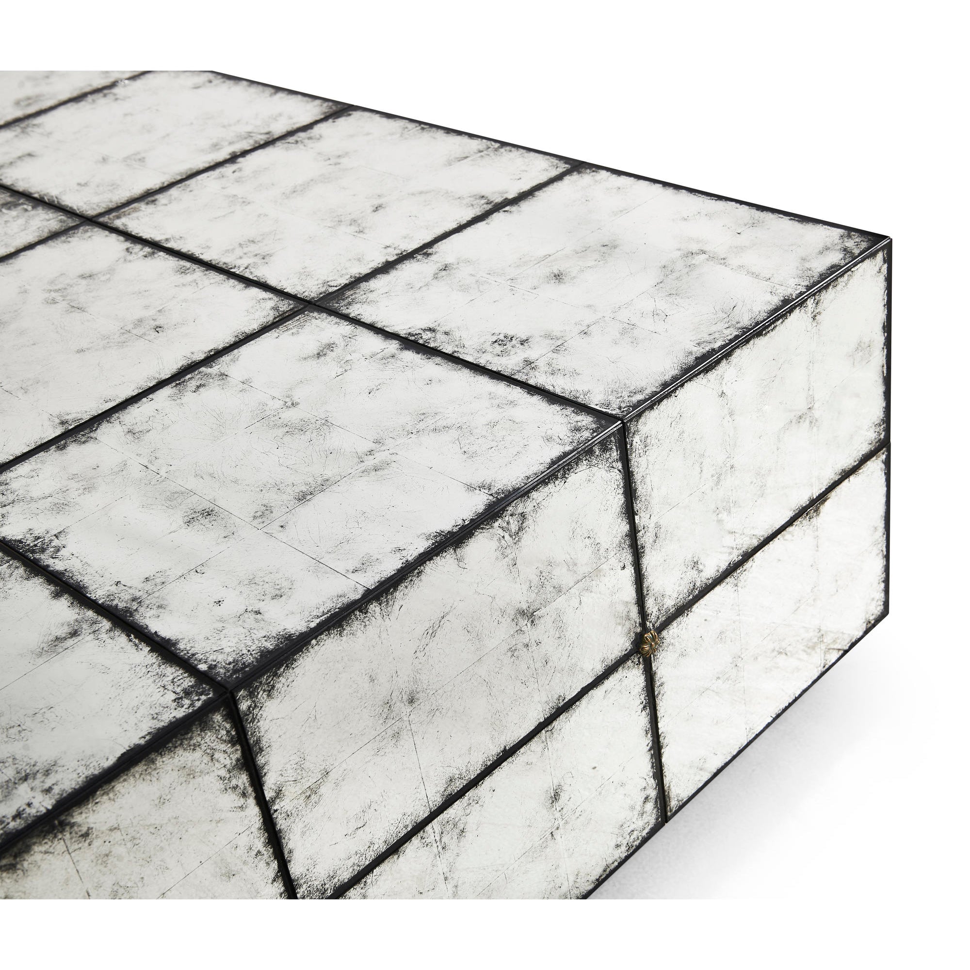 Close-up corner, textured mirrored cocktail table design.
