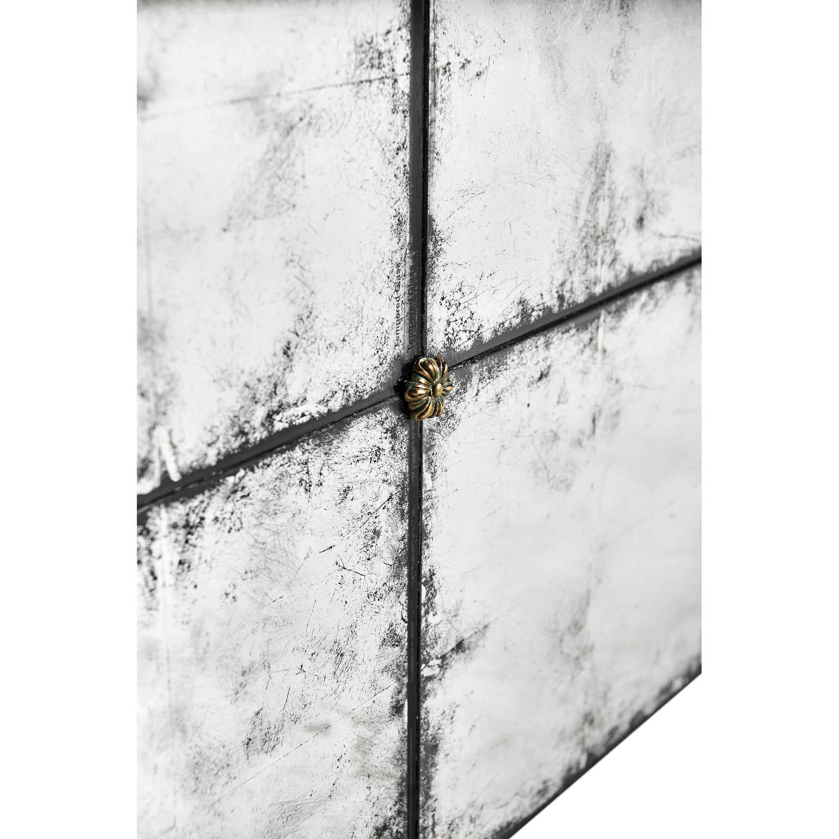 Close-up, metallic accent on mirrored cocktail table tile.
