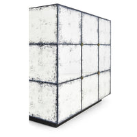 Side angle of mirrored end table reflecting light.