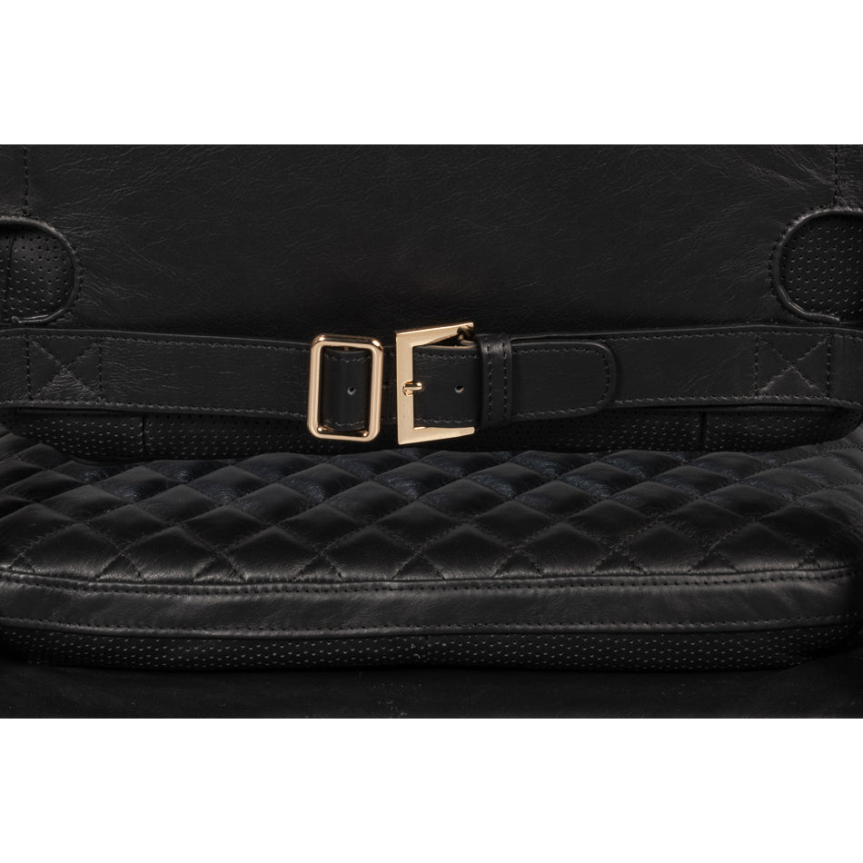 Strap detail on back of black leather chair.