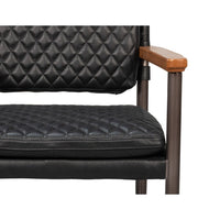 Front close-up of black quilted leather seat.