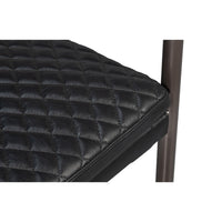 Quilted seat detail on black leather armchair.