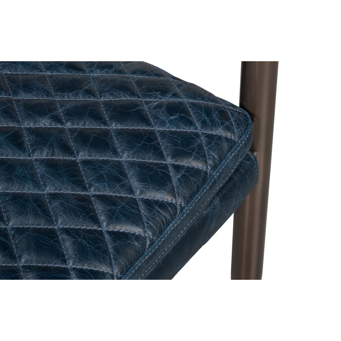 Quilted seat corner detail, blue leather armchair.