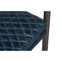 Quilted seat corner detail, blue leather armchair.