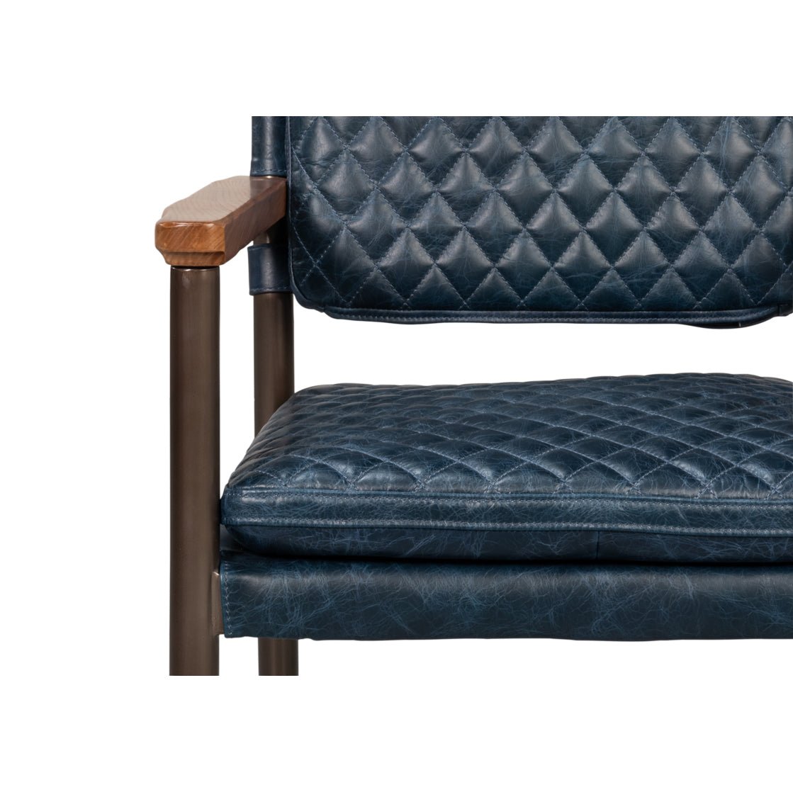 Front close-up of blue leather armchair, cushion detail.