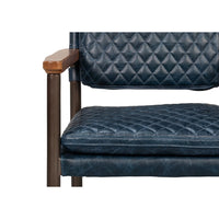 Front close-up of blue leather armchair, cushion detail.
