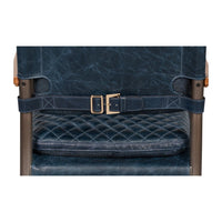 Back buckle detail on blue leather armchair, quilted texture.