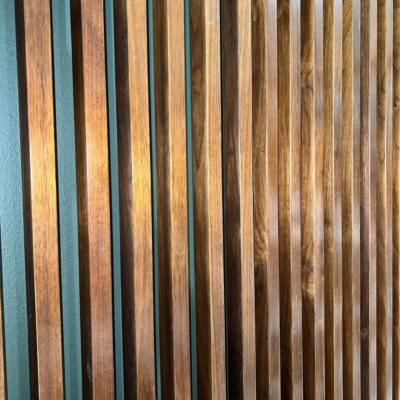 Close-up of wooden slatted headboard detail, dark wood.
