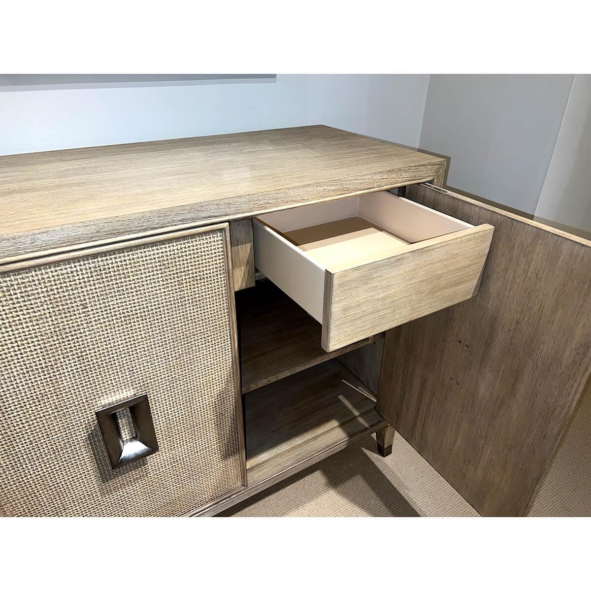 Open drawer in mid-century modern credenza, showing interior.