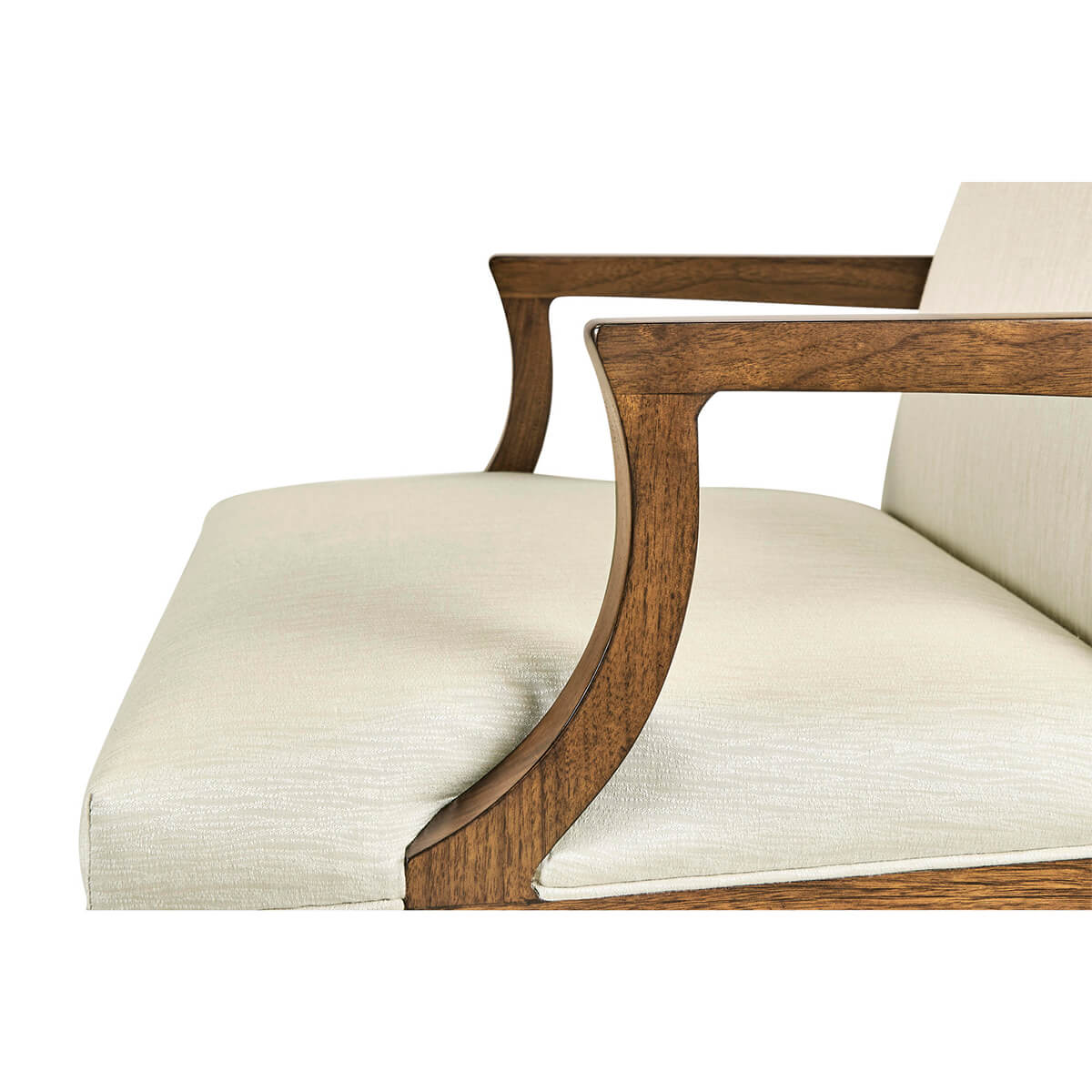 Close-up of armchair cushion and wooden armrest.