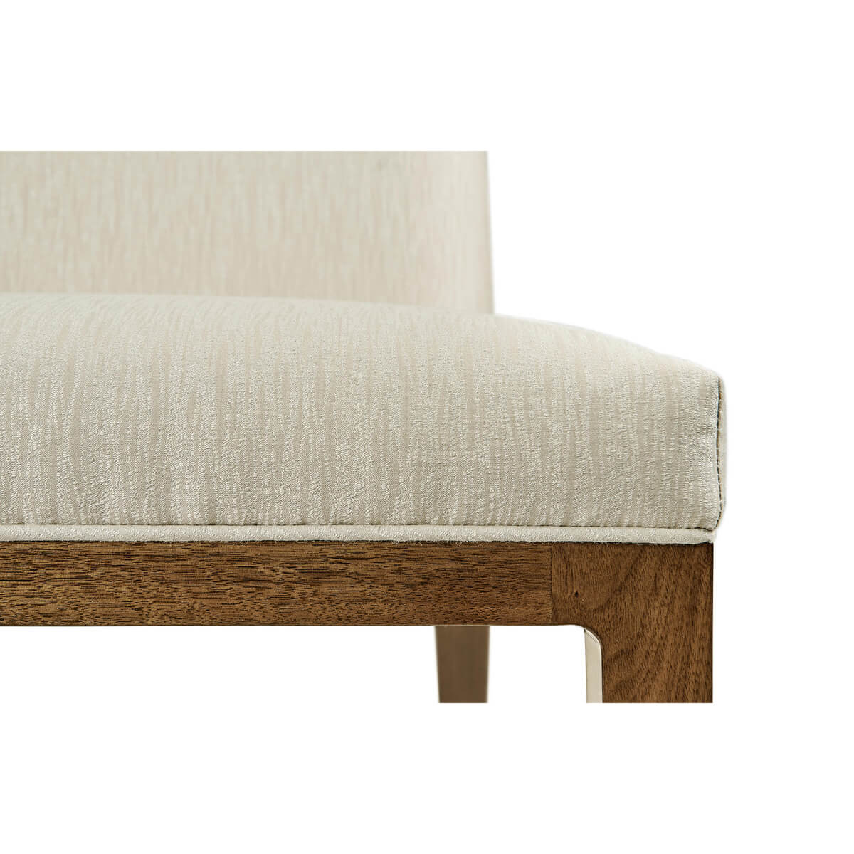 Close-up of cream upholstery on mid-century modern chair.