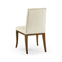 Back view of cream mid-century dining chair with wood legs.