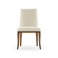 Front view of cream upholstered mid-century dining chair.