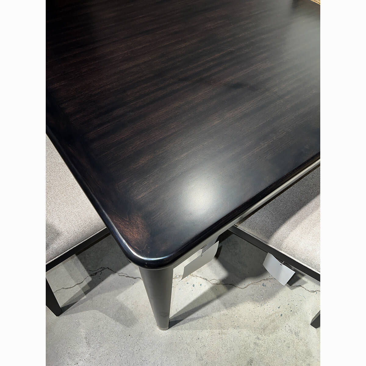 Close-up of espresso-finished game table corner detail.