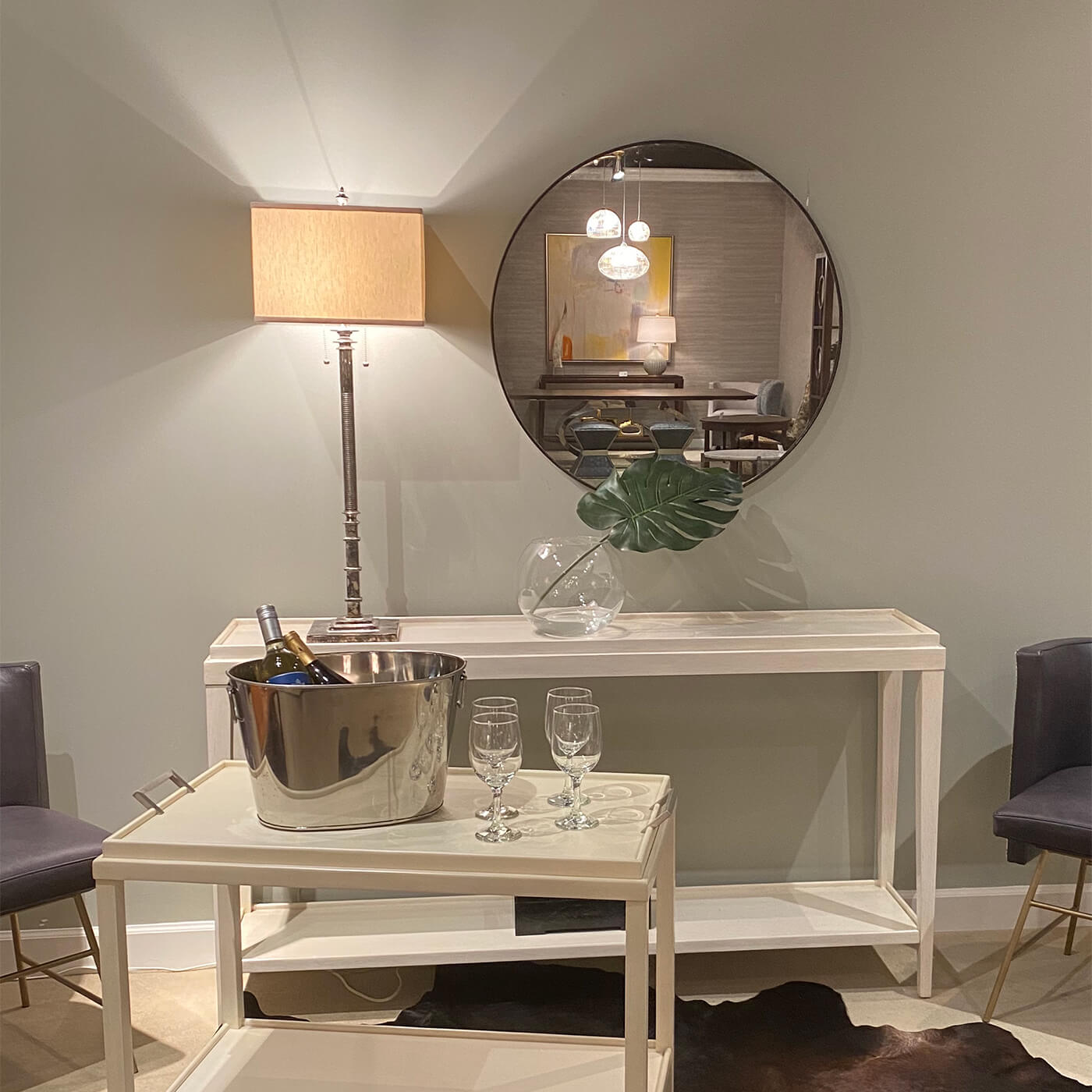 Gilt mirror mounted in elegant room setting.