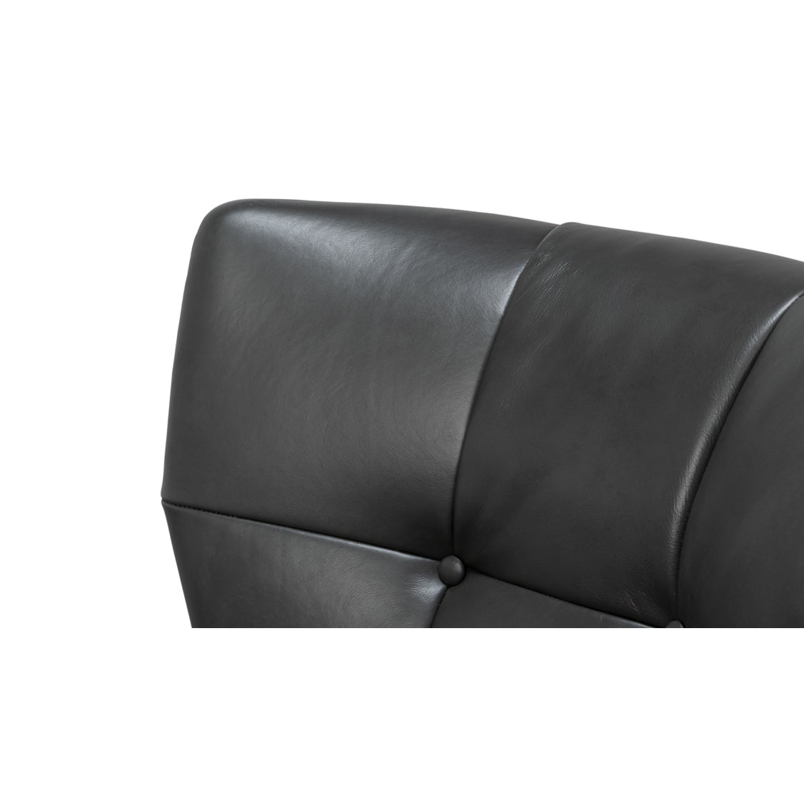 Button tufted back detail on leather armchair.