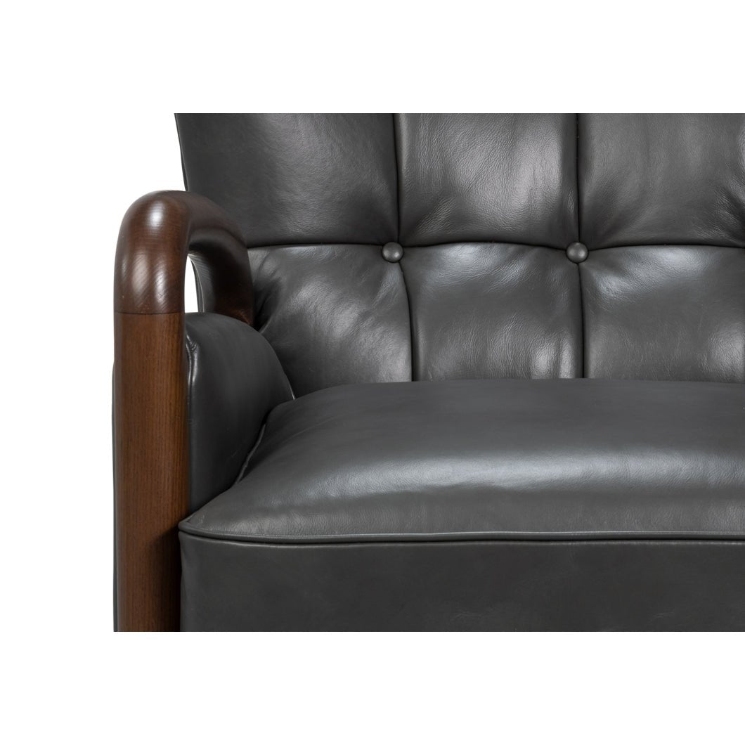 Armchair seat with button-tufted back in gray leather.