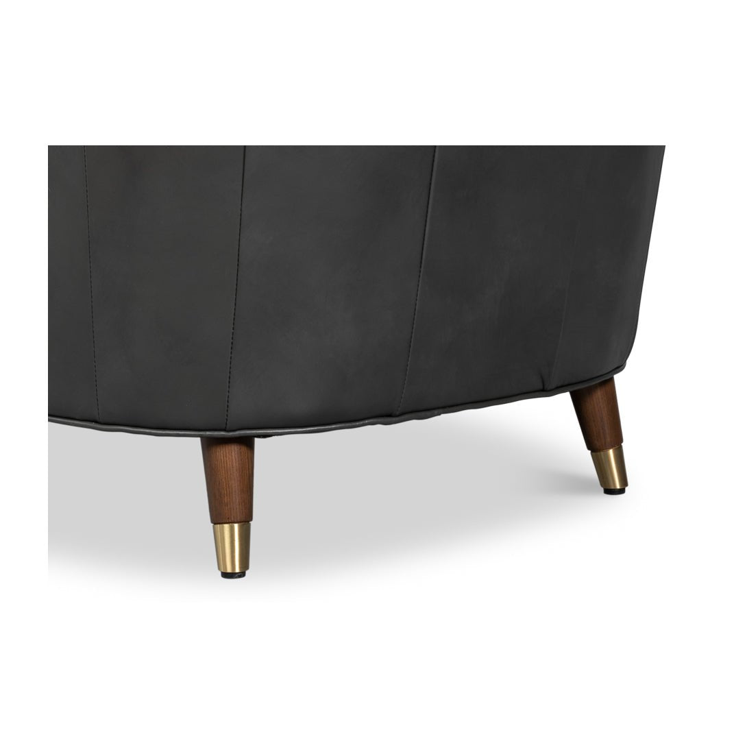 Chair leg detail with wood and brass accents.