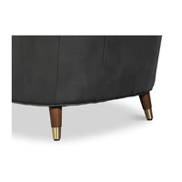 Chair leg detail with wood and brass accents.