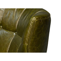 Corner close-up of armchair's button-tufted leather detail.
