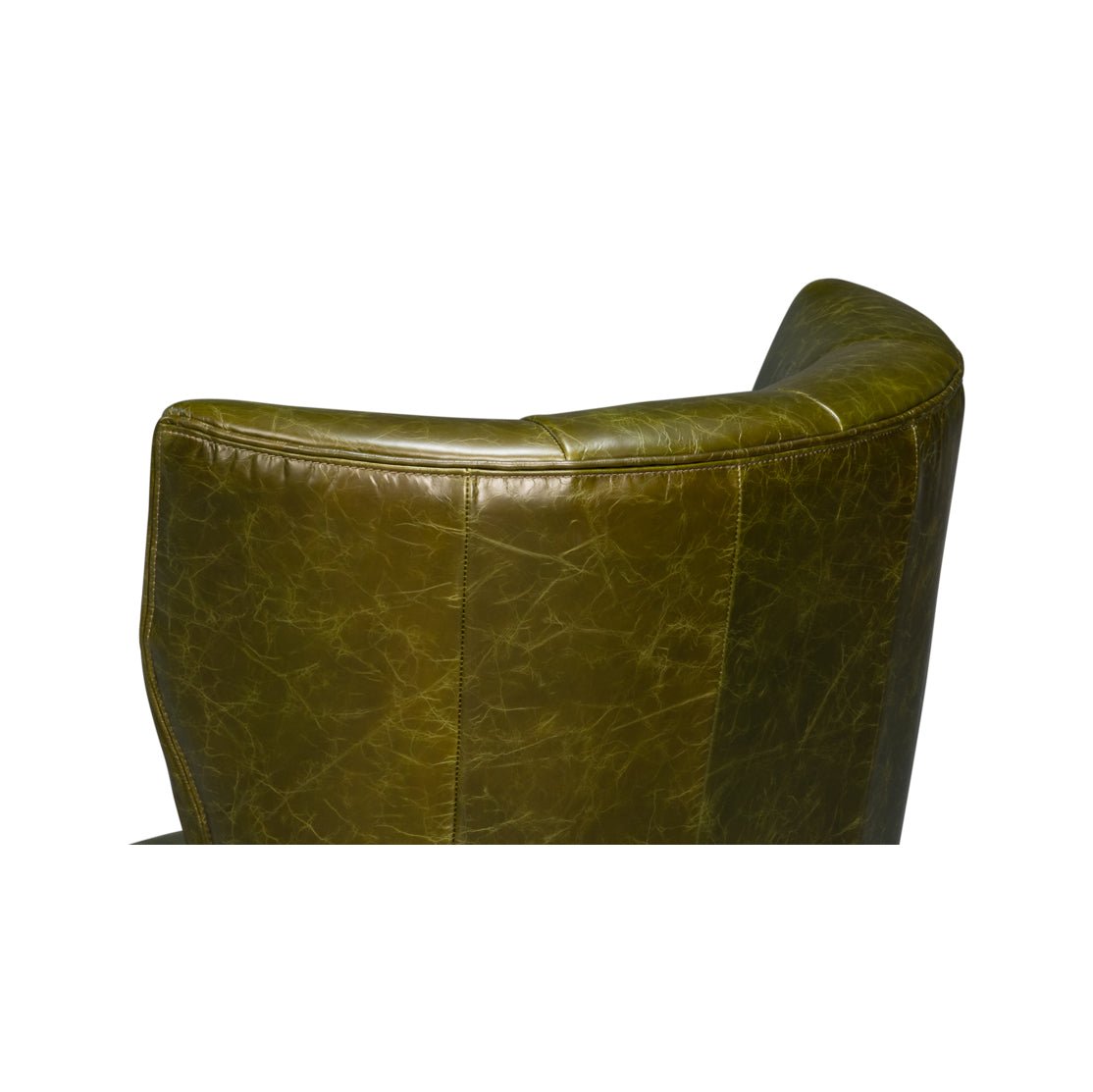 Close-up of armchair top highlighting green leather texture.