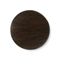 Top view of dark round dining table surface.