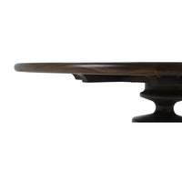 Side view of the dining table's edge and pedestal.
