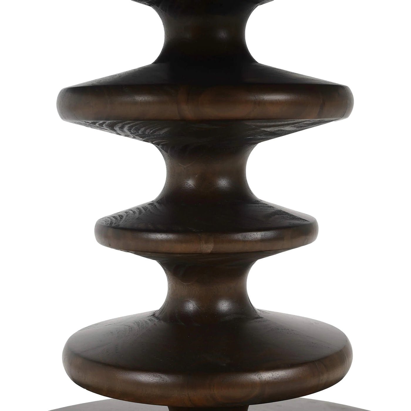 Close-up of dining table's artistic pedestal detail.
