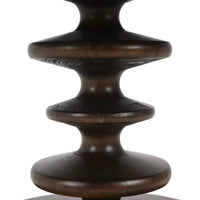 Close-up of dining table's artistic pedestal detail.