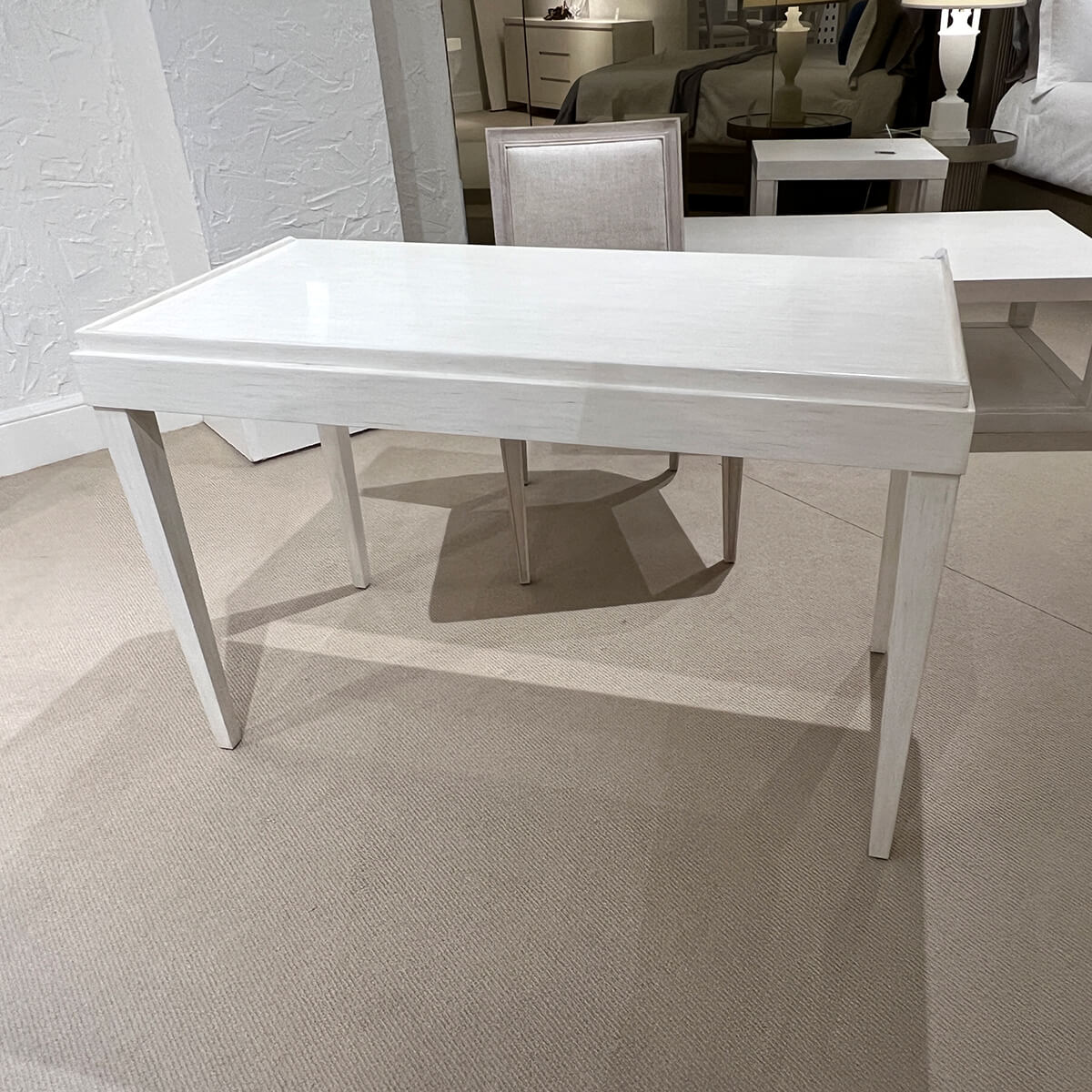 Mid-century modern desk in showroom, side angle view.