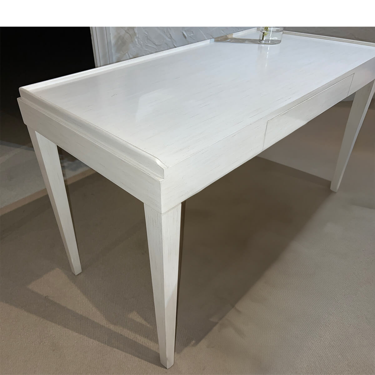 Mid-century modern desk, close-up of surface, drift white.