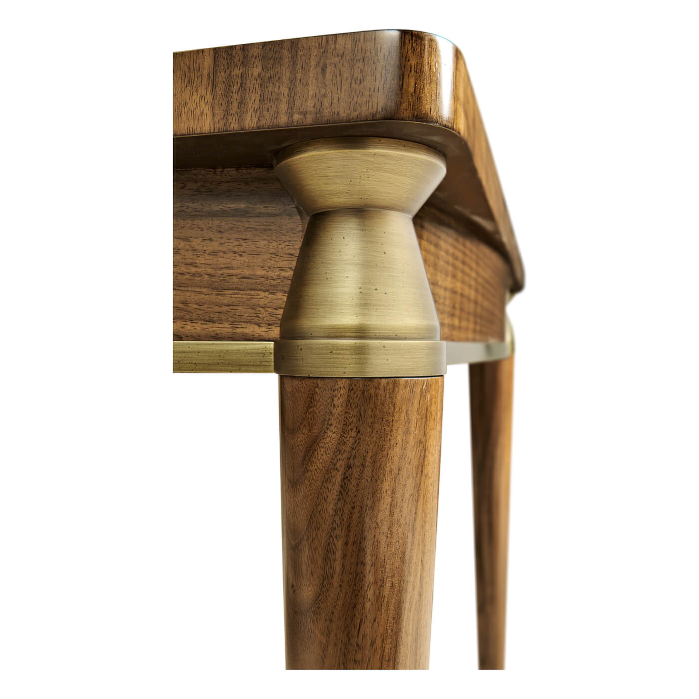 Close-up of walnut desk's brass-accented leg design.