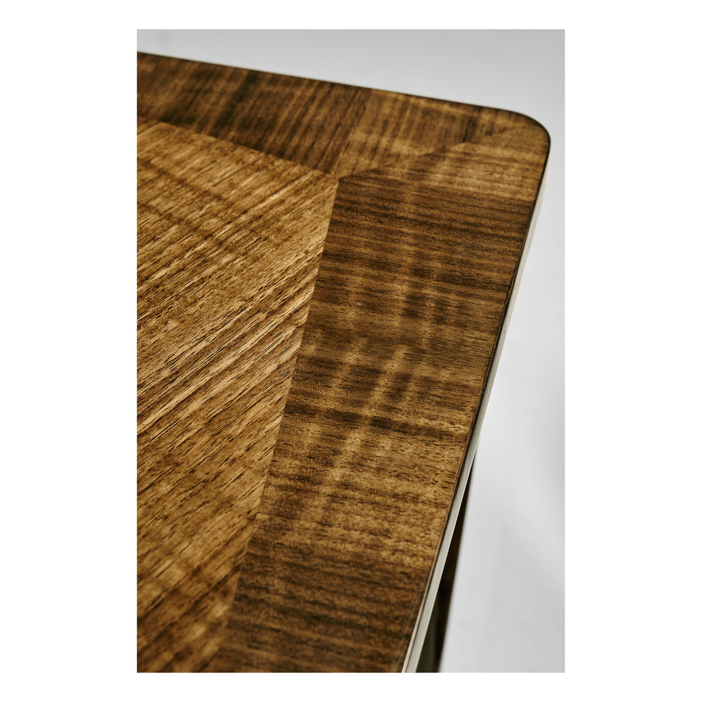 Close-up of walnut desk's rich wood grain texture.