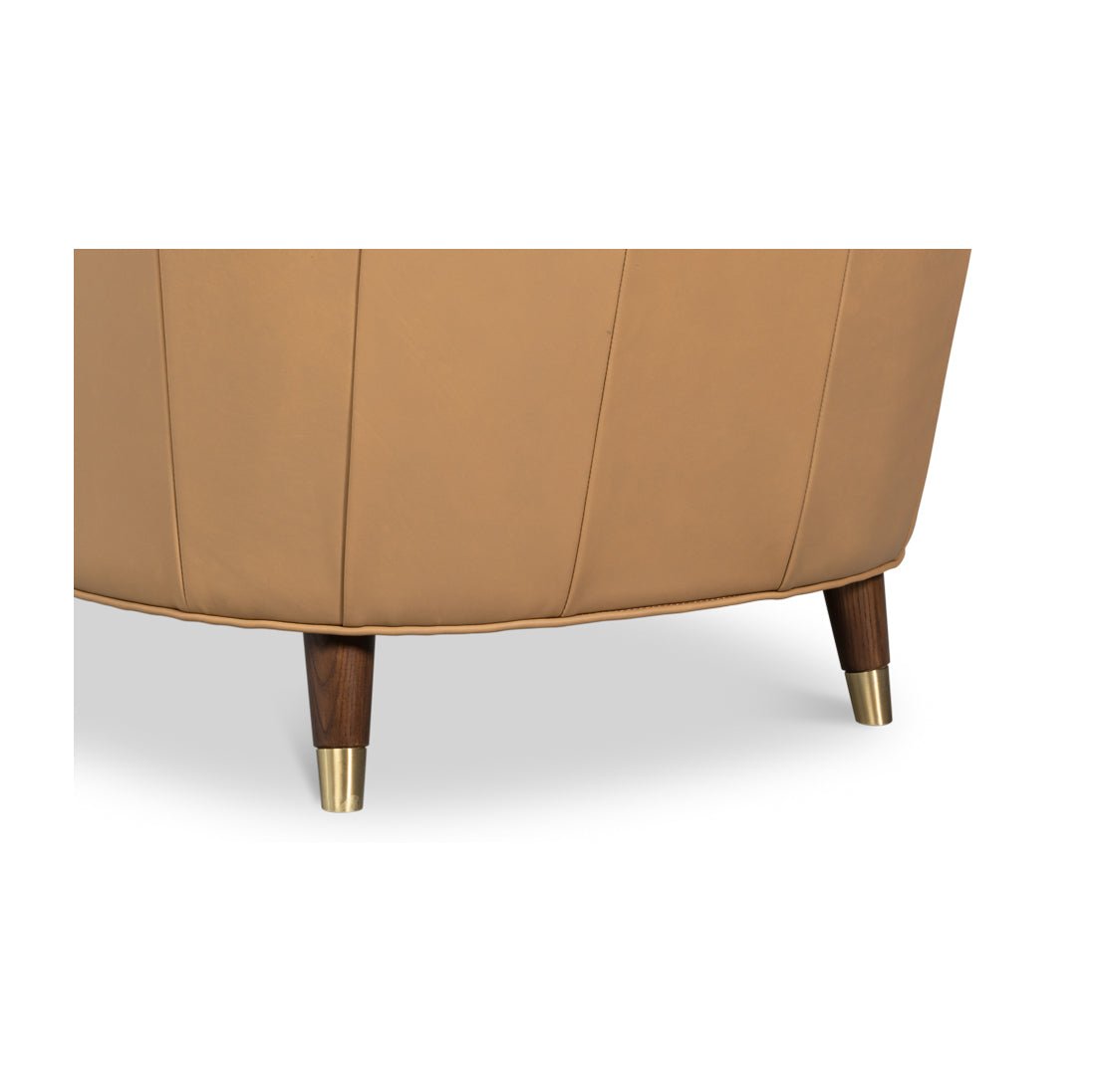 Armchair leg close-up, wooden and brass foot detail.
