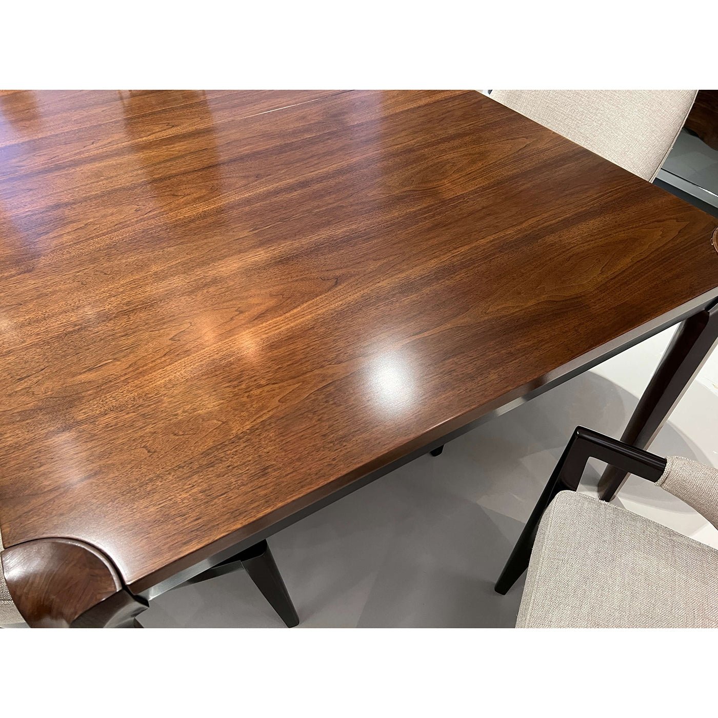 Walnut tabletop, seating arrangement, elegant mid-century design.