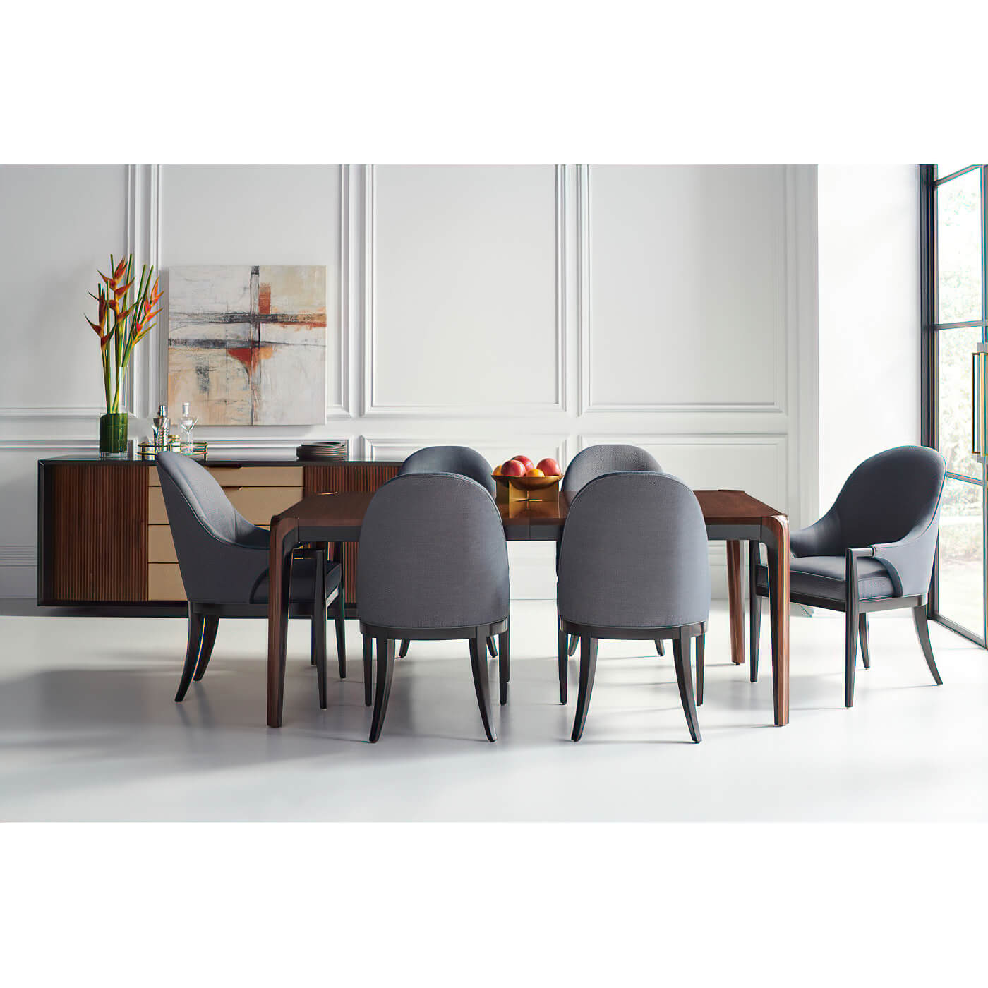 Dining chairs around walnut table, mid-century modern setup.