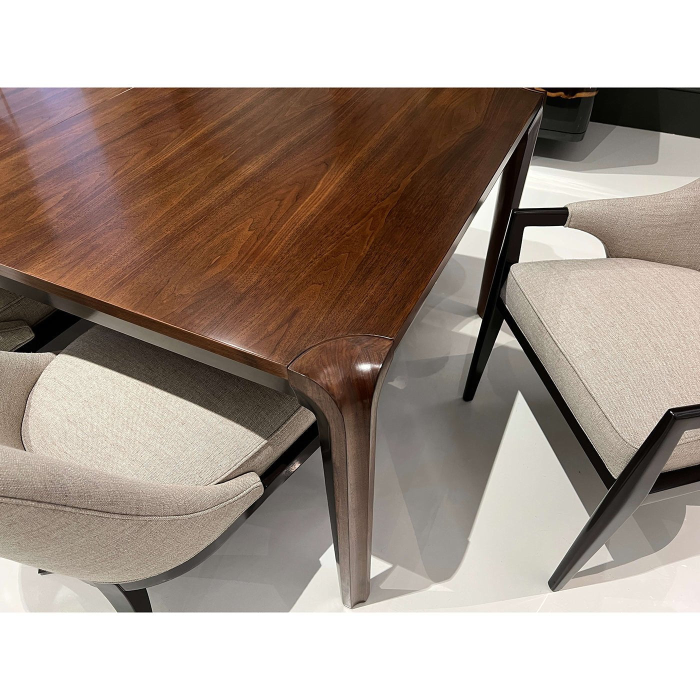 Close-up of dining table corner, detailed walnut finish.