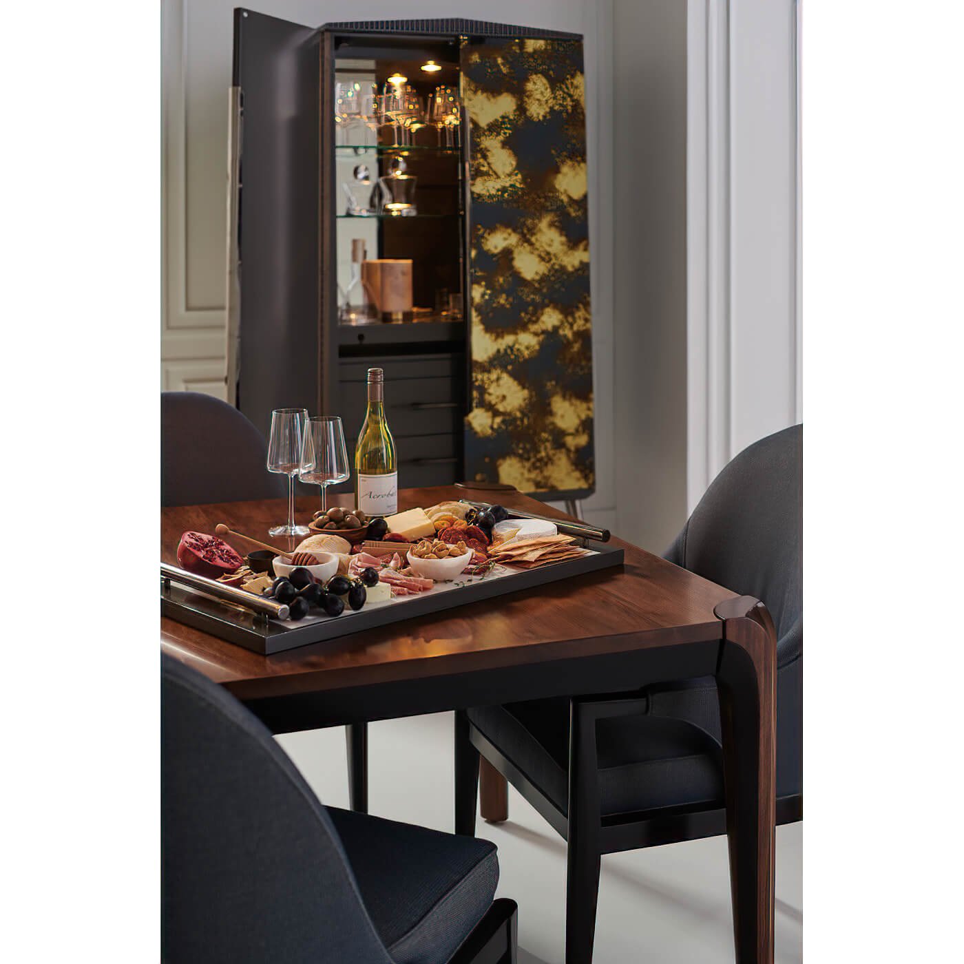 Dining table with charcuterie board, elegant walnut surface.