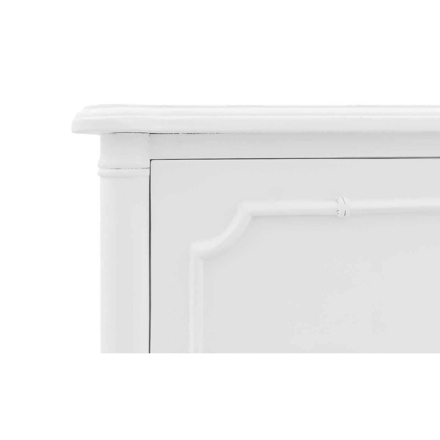 Close-up of white nightstand top corner detail.