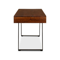 Side view of mid-century desk, wooden top, metal legs.