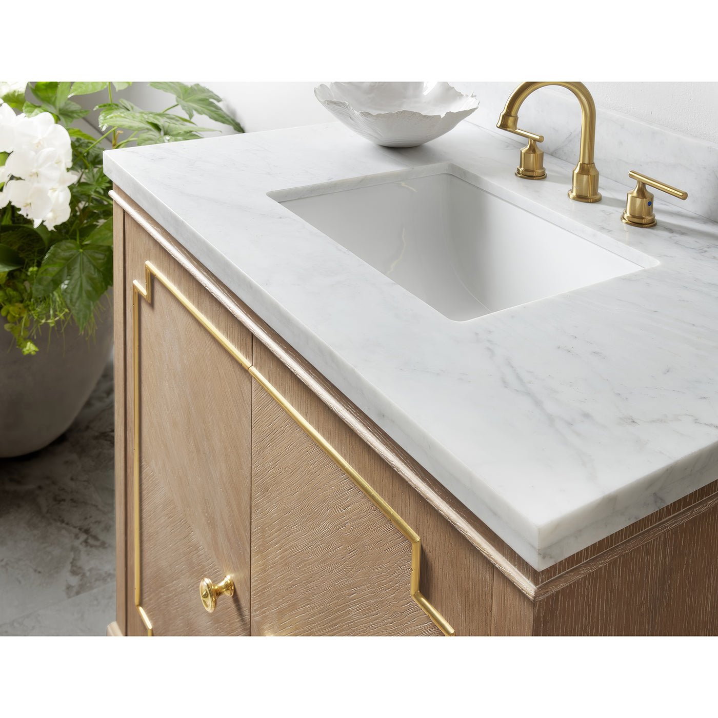 Close-up of Mid Century Oak Vanity sink and marble countertop.