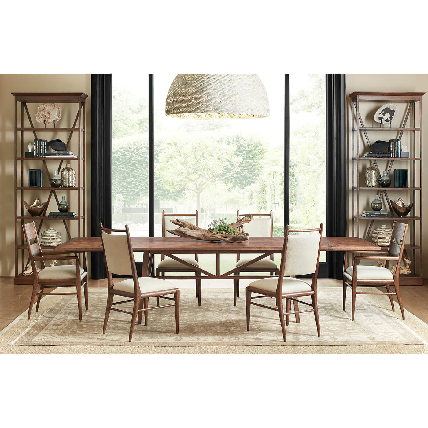 Dining room with oak armchairs and table setting.