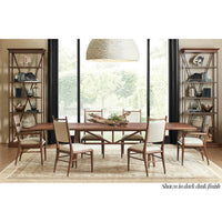 Dining set with mid-century oak chairs in room.
