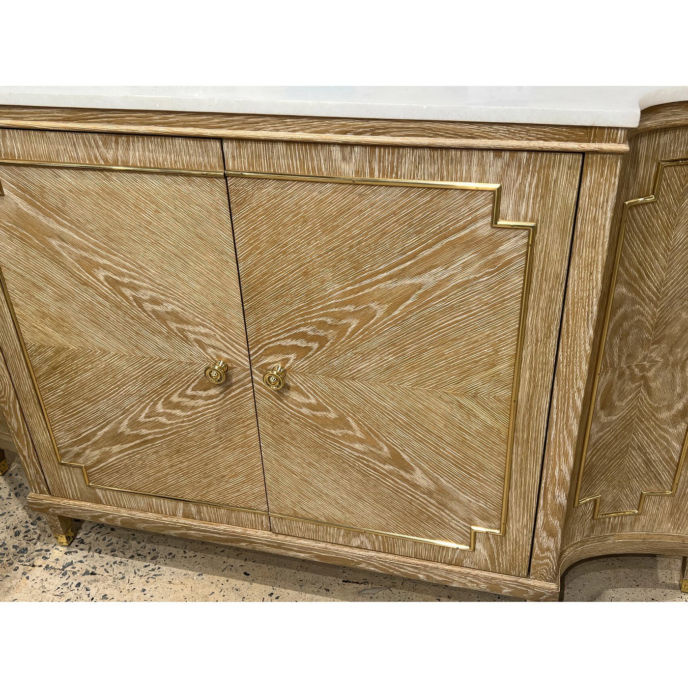 Close-up of Mid Century oak sideboard doors, brass accents.